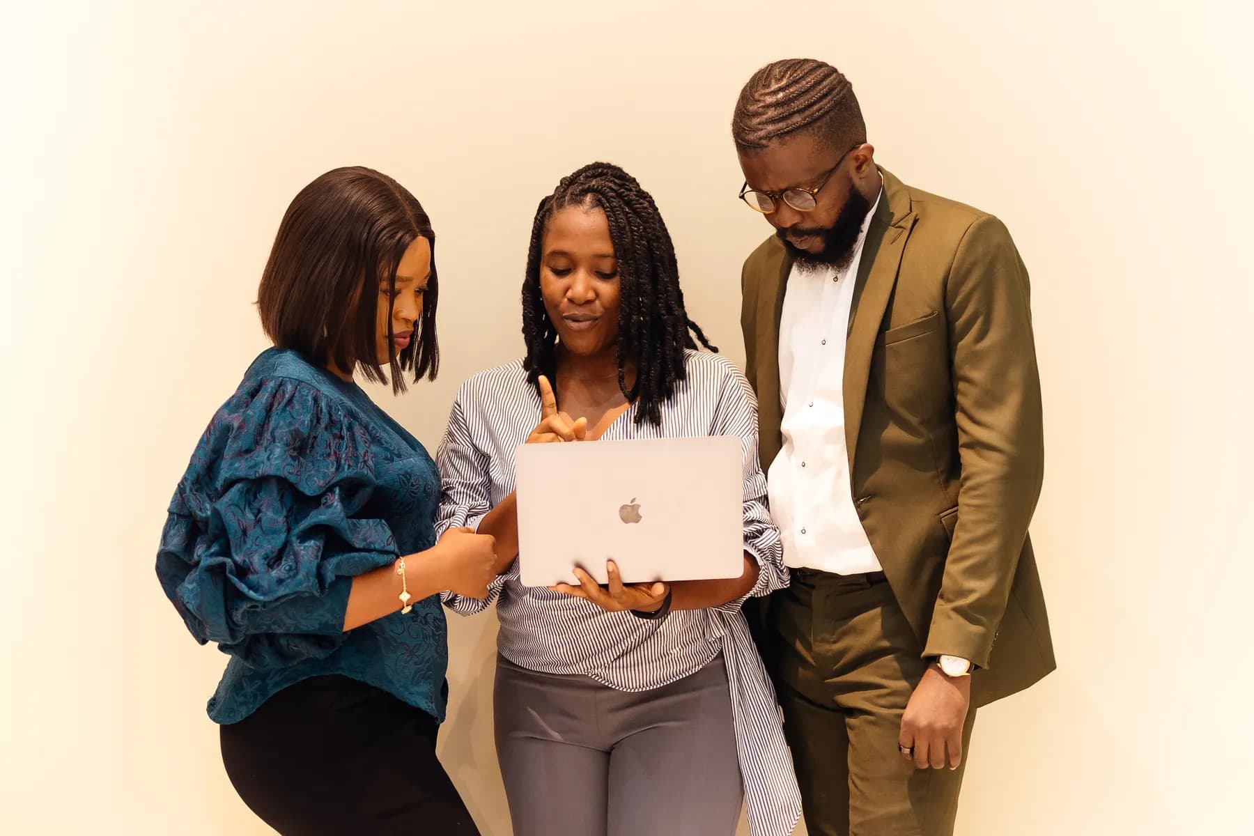 African professionals learning together around a laptop
